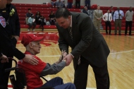 Gary "Cowboy" McCowan shaking head coach Joe Luce's hand before the game after being celebrated as the #1 Jeff fan.