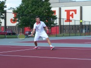 Sophomore Adam Crawford hits a forehand return to the Jeffersonville one doubles team in warm ups
